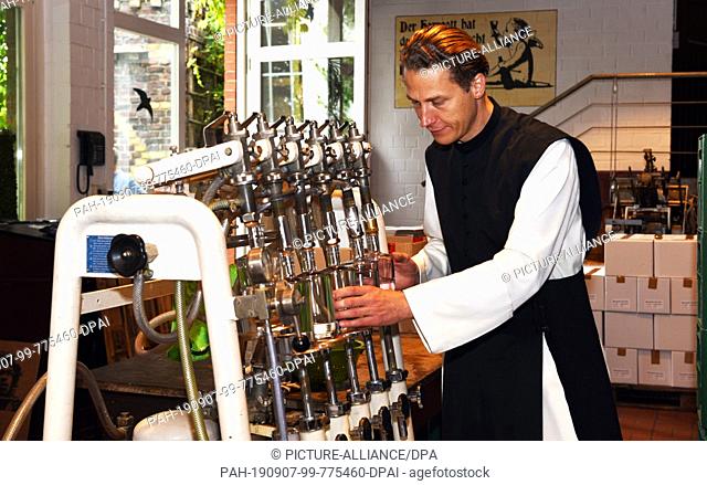 04 September 2019, North Rhine-Westphalia, Bochum: Father Justinus stands in the distillery and bottles his gin. In his own production he produces high...