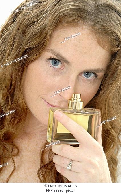 Redhead lady with parfume bottle