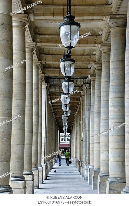 Friends walking between columns