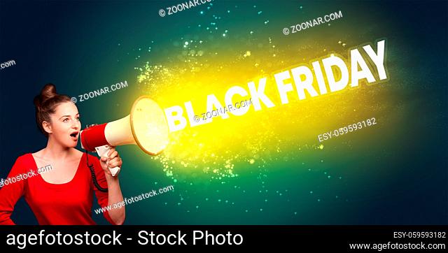 Young woman yelling to loudspeaker with BLACK FRIDAY inscription, modern media concept