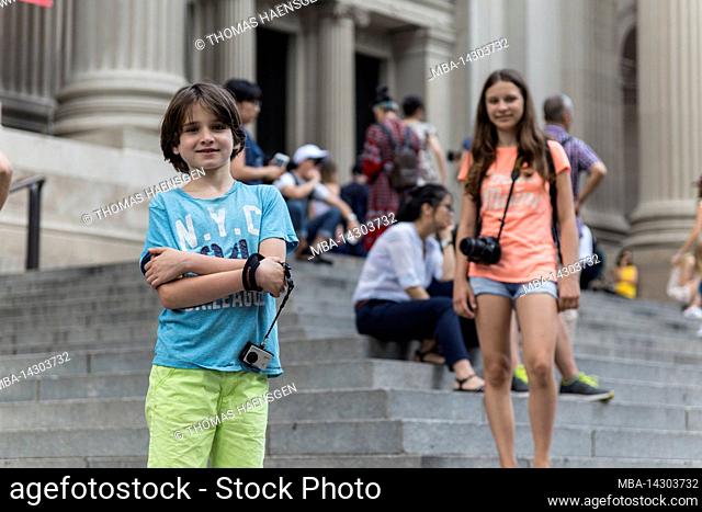 Upper East Side, New York City, NY, USA, 14 years old caucasian teenager girl and 12 years old caucasian teenager boy - both with brown hair and summer styling...