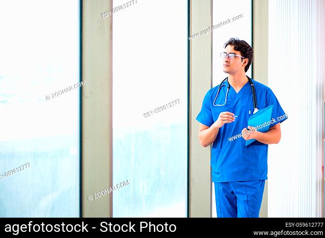 Young handsome doctor working in the hospital