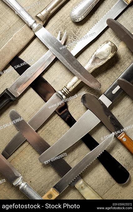 Collection of knifes on a wood table