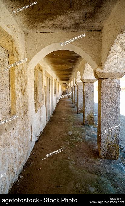 A cloister with cells of the pilgrims in Nossa Senhora do Cabo Church on the cape Espichel in Sesimbra, Portugal