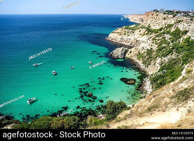 boats and yachts in the crystal clear azure sea on a sunny day. cape fiolent in sevastopol. the concept of an ideal place for summer travel and relaxation