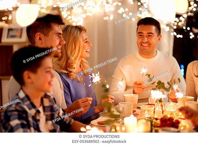 family with sparklers having tea party at home