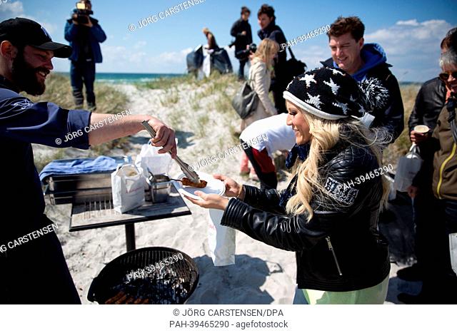 Singer Natalie Horler from the band Cascada representing Germany gets grilled chicken during a trip of the German delegation to Skanoer during the Eurovision...