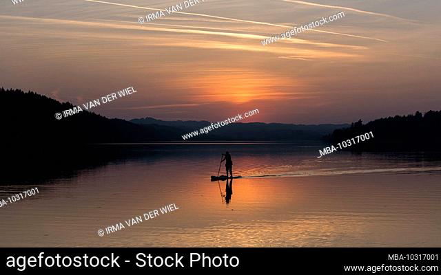 Summer in Bavaria. Impressions from the foothills of the Alps: Stand Up Paddler on the Staffelsee at sunset