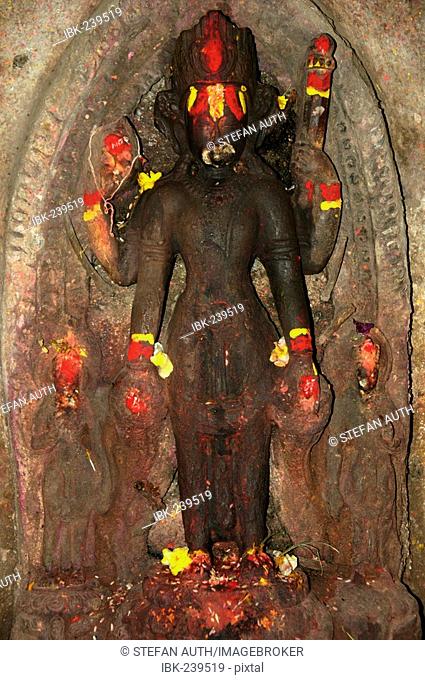 Old relief of god Vishnu with red and yellow paint Kathmandu Nepal