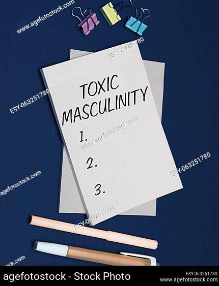 Hand writing sign Toxic Masculinity, Concept meaning describes narrow repressive type of ideas about the male gender role