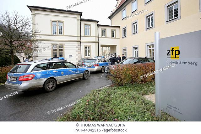 Police cars stand in front of the Center for Psychiatry in Zwiefalt, Germany, 13 November 2013. At night to criminals escaped from the secure unit of the center