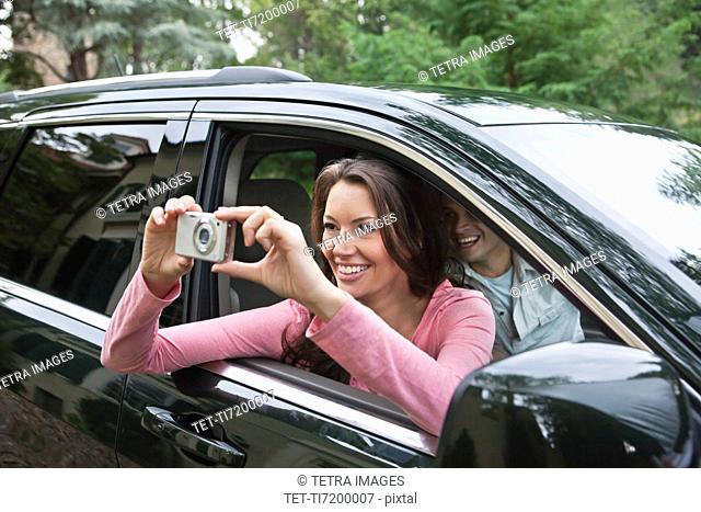 USA, New Jersey, Woman taking pictures from car