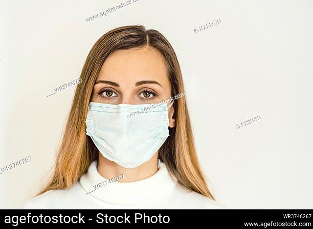Worried woman during Covid-19 crisis in quarantine looking at camera