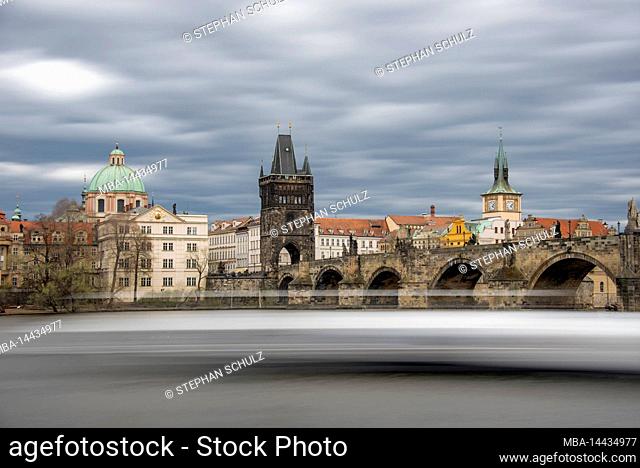 View of Charles Bridge with the Old Town Bridge Tower, on the left the Church of the Holy Cross, Prague, Czech Republic