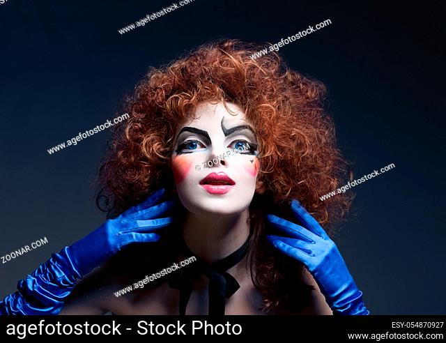 Woman mime with theatrical make-up. Studio shot