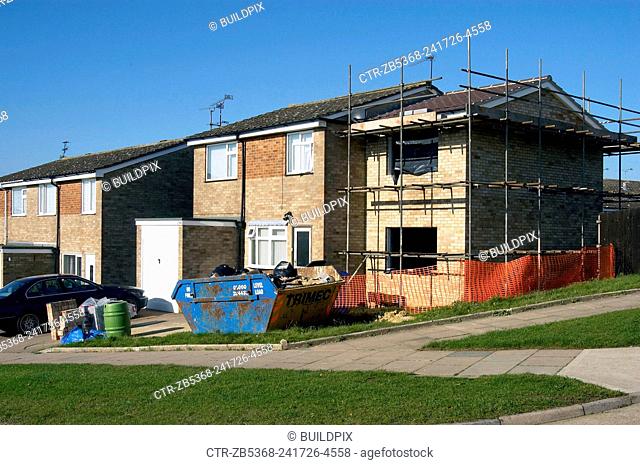 Extension being built on the side of a council house, England, UK