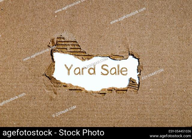The word yard sale appearing behind torn paper