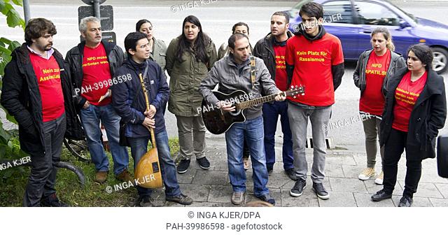 Members of the band 'Grup Yorum' and supporters of the organization 'Anatolian Federation' perform a song opposite of the Higher Regional Court in Munich
