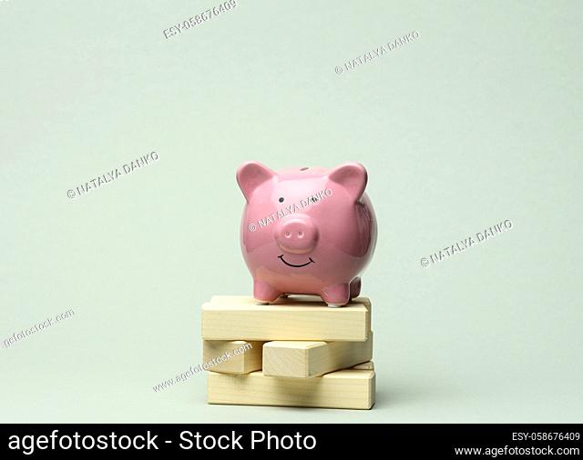 ceramic pink piggy bank on gray background. Concept of increasing income from bank accounts, savings