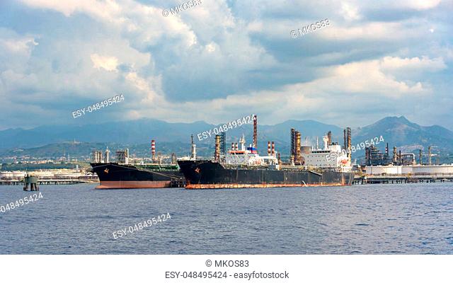 View of big ships in industrial zone in Milazzo on Sicily, Italy