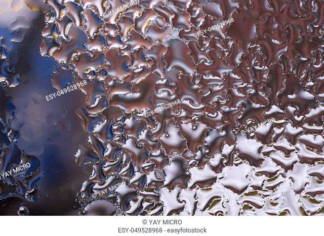 Water drops on glass window close up with blurred background. Drops in macro. Condensate on window closeup. Wet air