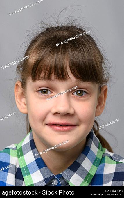 Portrait of a joyfully surprised ten-year-old girl of European appearance, close-up