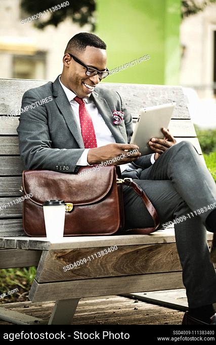 Black businessman using digital tablet outdoors