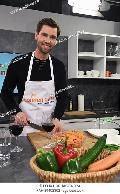 Alexander Keen cuts meat prior to the live show 'Kueche & Co - Die Reiseshow' (lit. Kitchen & Co. - The travel show) in the Sonnenklar TV studio in Munich