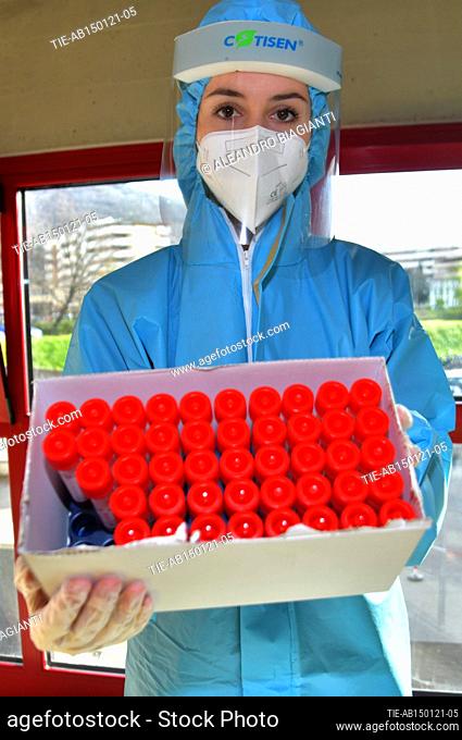 Medical workers arranges vials containing swab samples in the high school , Prato, ITALY-15-01-2021