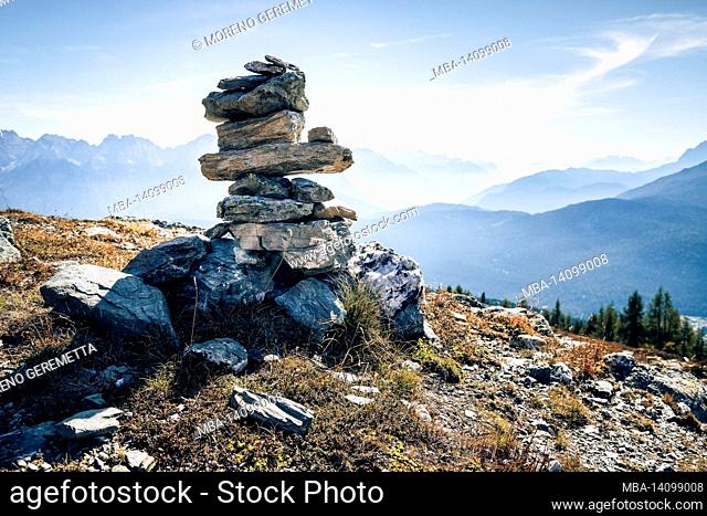 stoanerne mandln, cairn or stone man along the path of the carnic crossing on the border crest between italy and austria, eastern alps, carnic pre-alps