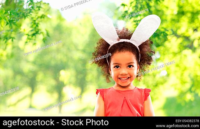 happy little girl wearing easter bunny ears