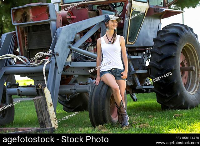 model posing as a farmers daughter in a rural environment