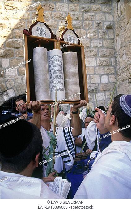At the Jewish Sukkot festival, men gather at the Wailing Wall religious site, to pray together. Torah scrolls are processed and held up