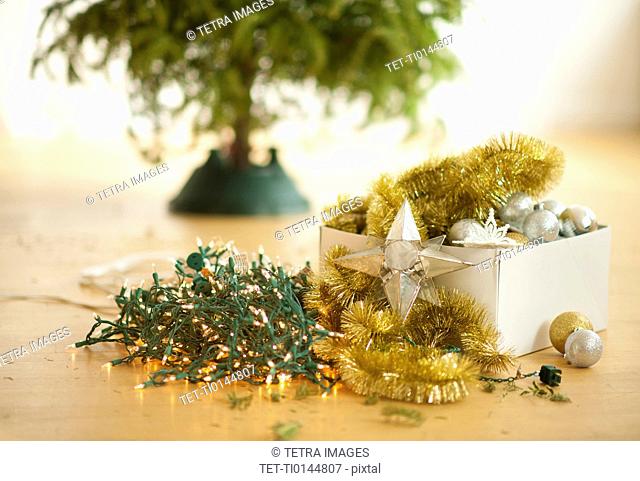 Christmas tree and christmas ornaments on floor