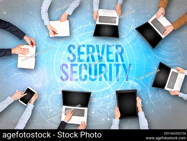 Group of people in front of a laptop with SERVER SECURITY insciption, web security concept