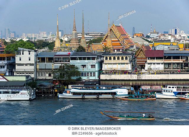 Boats on the Chao Phraya River with views of the city, Bangkok, Thailand, Asia