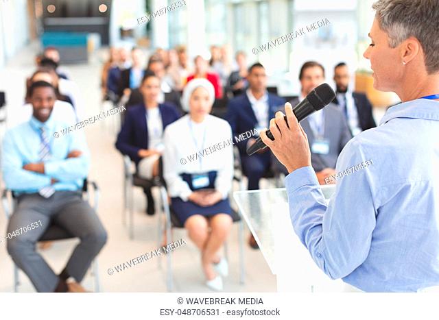 Female speaker speaks in a business seminar