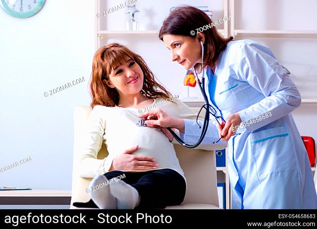 The young pregnant woman visiting experienced doctor gynecologist