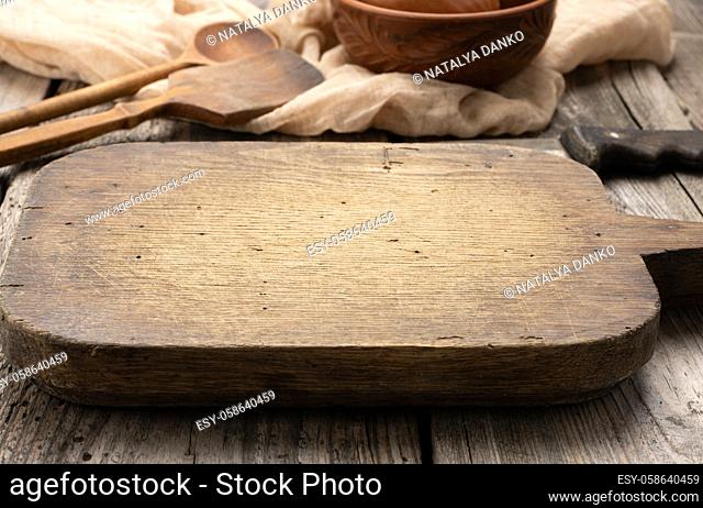 very okd empty rectangular wooden cutting kitchen board on table, top view