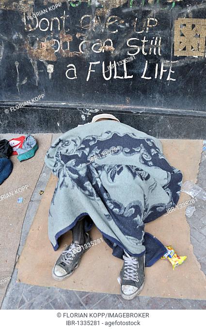 Emaciated street child, wrapped in a blanket on the sidewalk, Hillbrow district, Johannesburg, South Africa, Africa