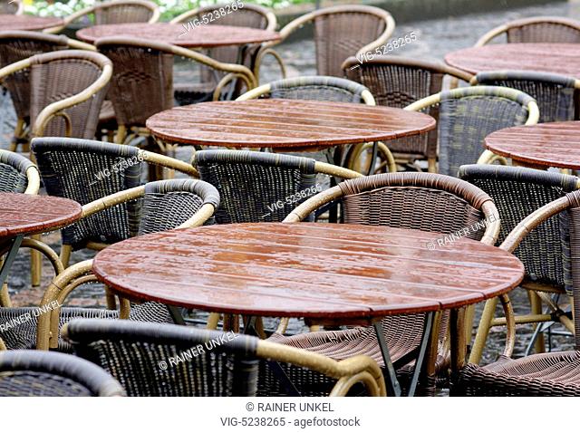 GERMANY, BONN, 02.04.2015, DEU , GERMANY : Tables of a cafe in the rain - Bonn, Northrhine-Westfalia, Germany, 02/04/2015
