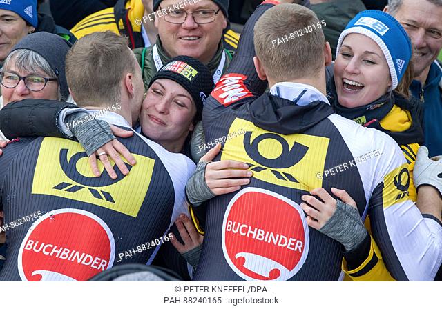 Bobsleigh athletes Francesco Friedrich (l) with wife Magdalena and Thorsten Margis his girlfriend Inken from Germany celebrate their first place victory...