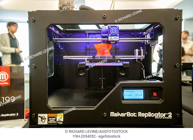 A $2199 MakerBot Industries ''Replicator 2'' 3d printer churns out a scanned gnome figure in the MakerBot offices in New York