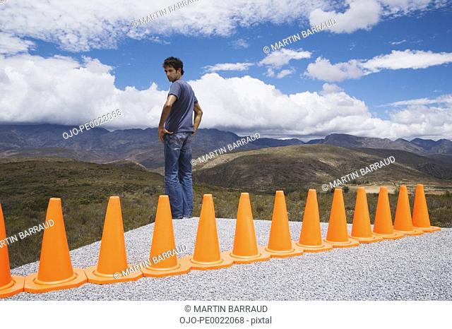 Man cornered by a row of safety cones