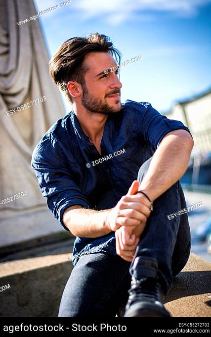 One handsome young man in urban setting in European city, Turin in Italy