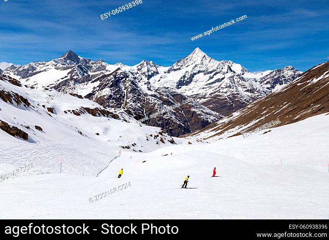 Zermatt, Switzerland - April 12, 2017: People skiing on ski pistes in the famous Matterhorn skiing area