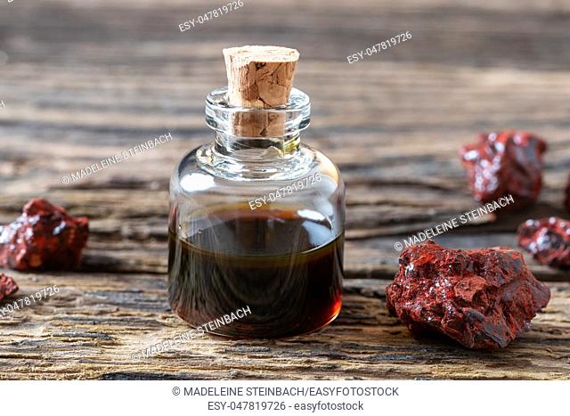 Croton lechleri, or sangre de drago oil and resin on a rustic background