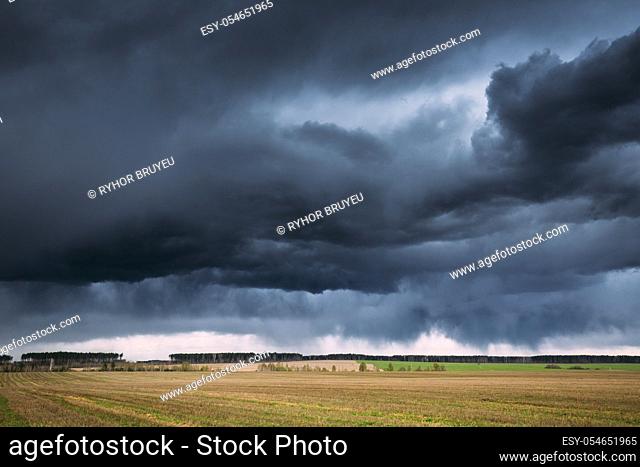 Countryside Rural Field Spring Meadow Landscape Under Scenic Dramatic Sky Before Rain. Rain Clouds On Horizon. Agricultural And Weather Forecast Concept