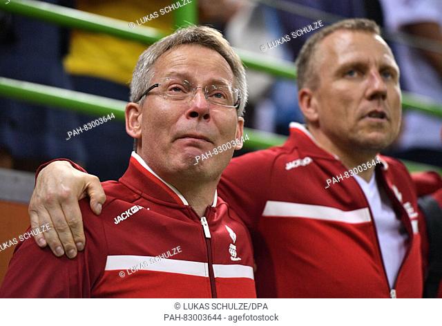 Coach Gudmundur Gudmundsson (L) of Denmark reacts after winning the Men's Gold Medal Match match between Denmark and France of the Handball events during the...
