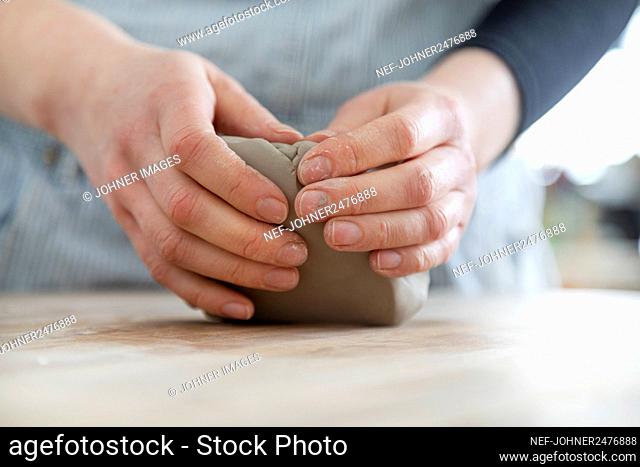 Womans hands modeling clay